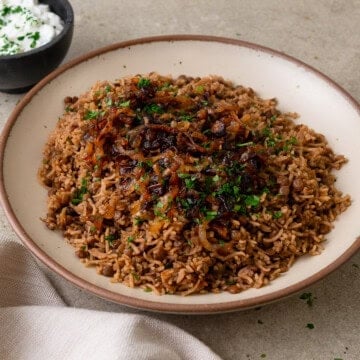 Lebanese mujadara is a vegan lentil and rice dish with fried onions and warm spices.