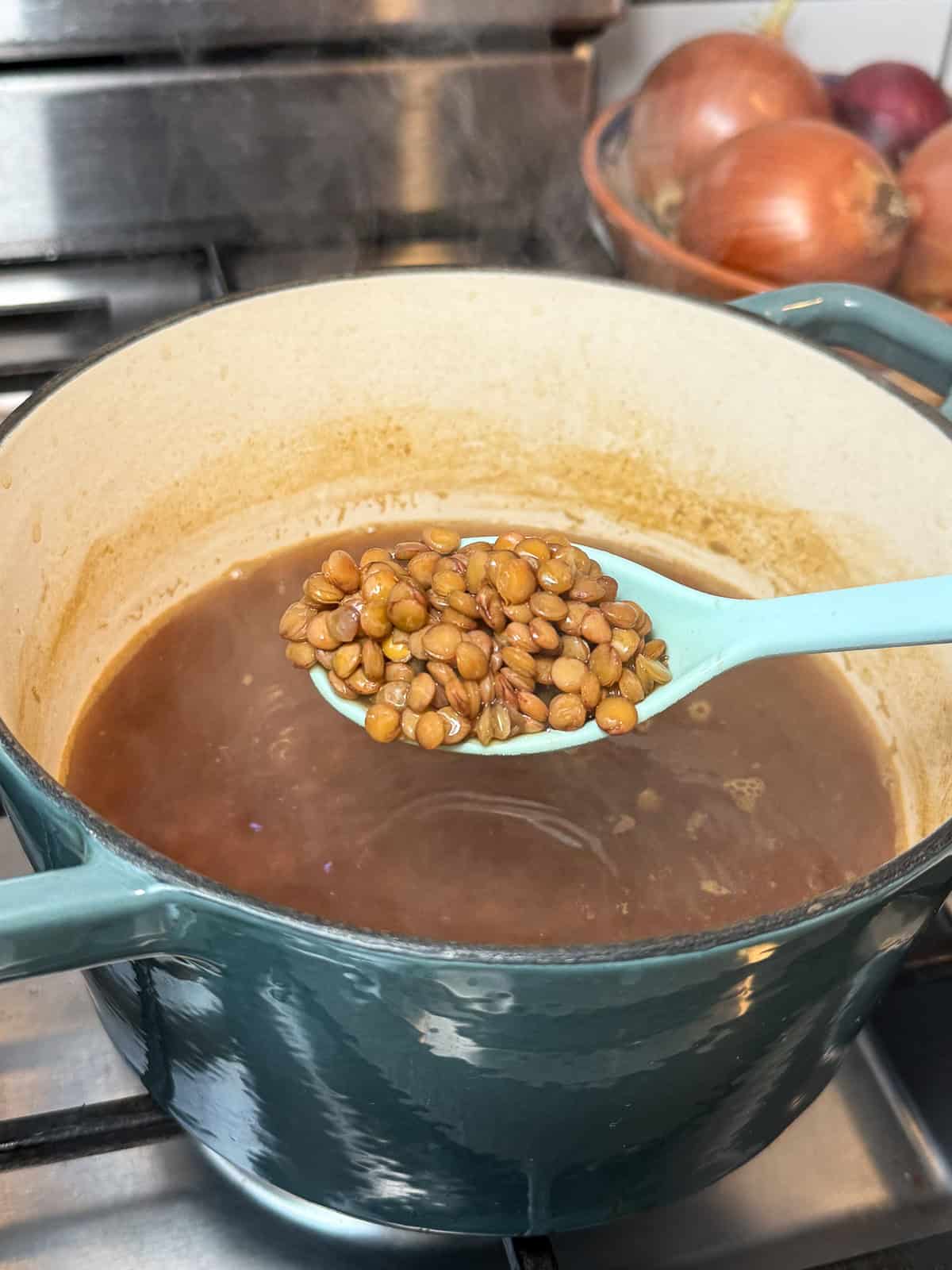 Par cook the lentils before adding the rice when making mujadara.