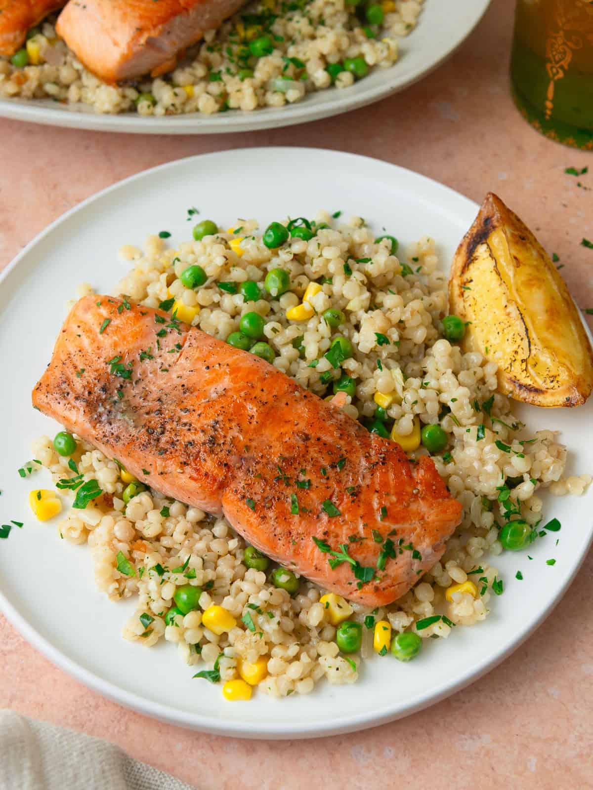 Serve the seared salmon alongside pearl couscous tossed with peas, corn and lemon vinaigrette.