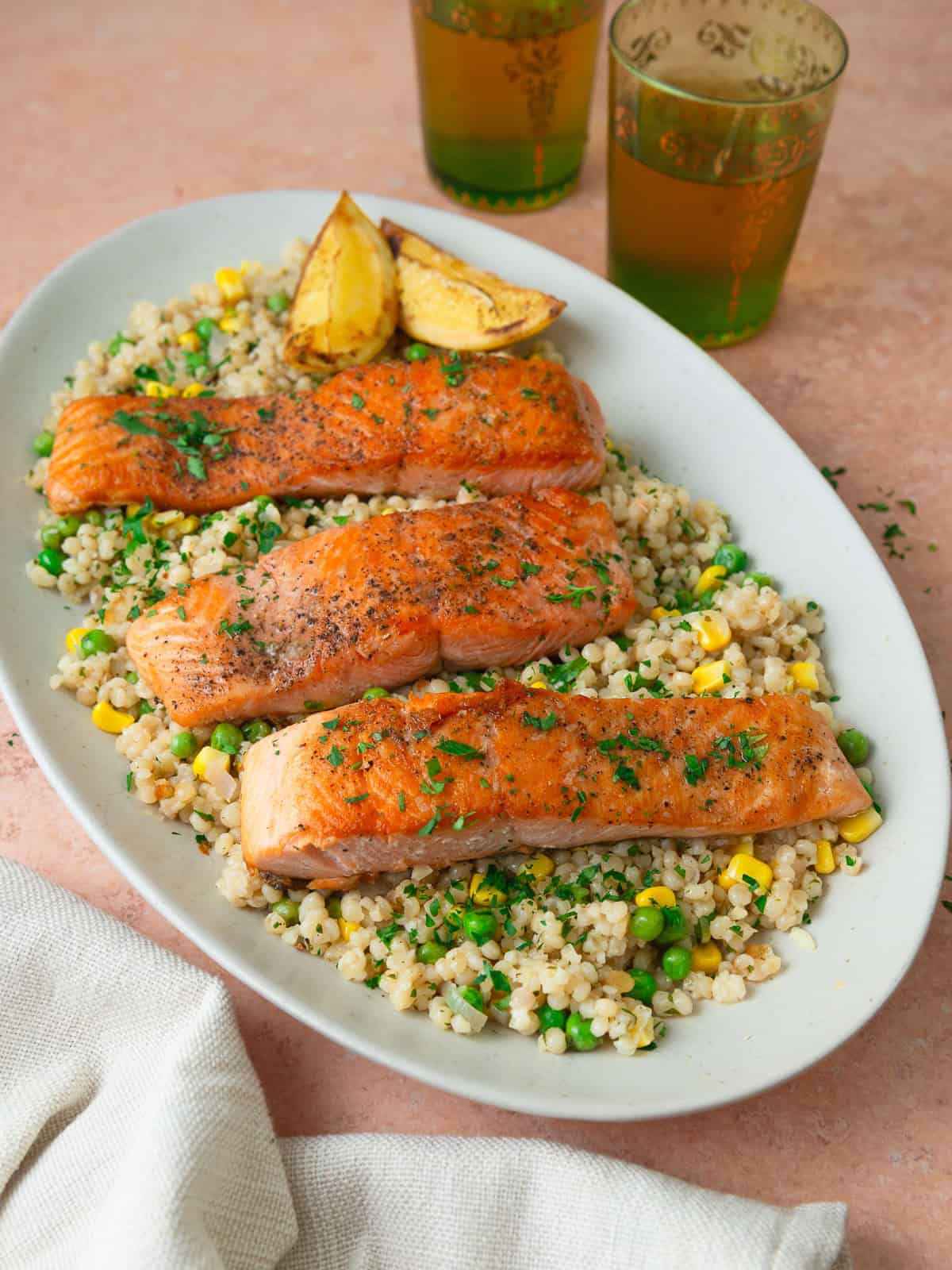 Seared salmon over perl couscous with a bright lemon and herb vinaigrette.