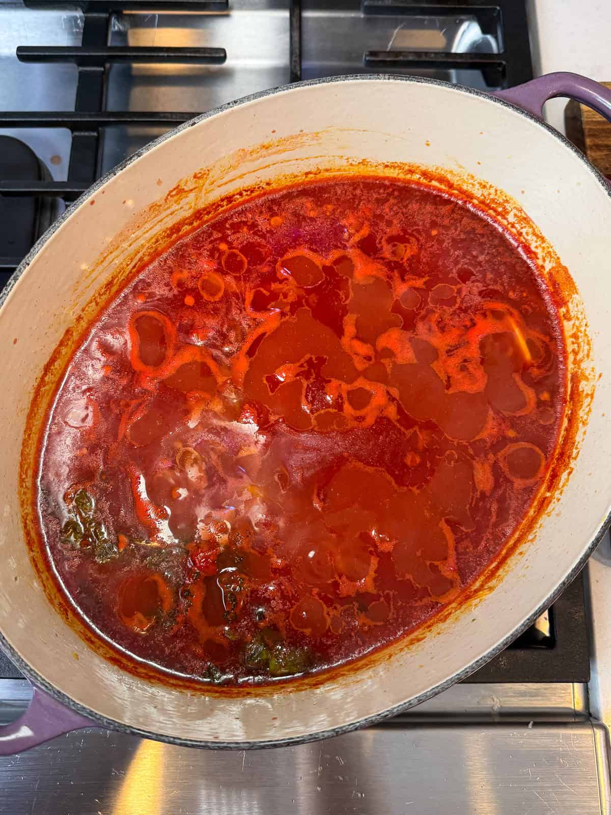 Simmer the tomato cioppino base for about 30 minutes before adding the seafood in.