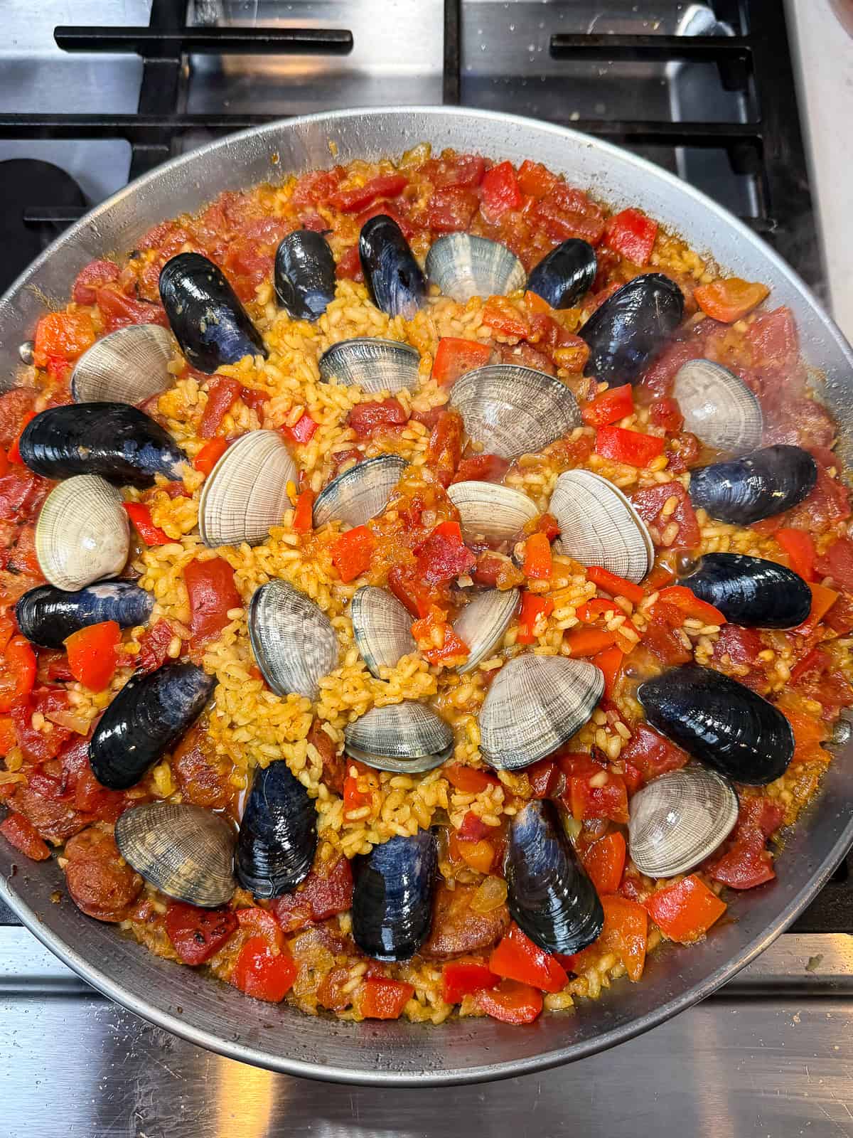 Add the mussels and clams to the chorizo paella.