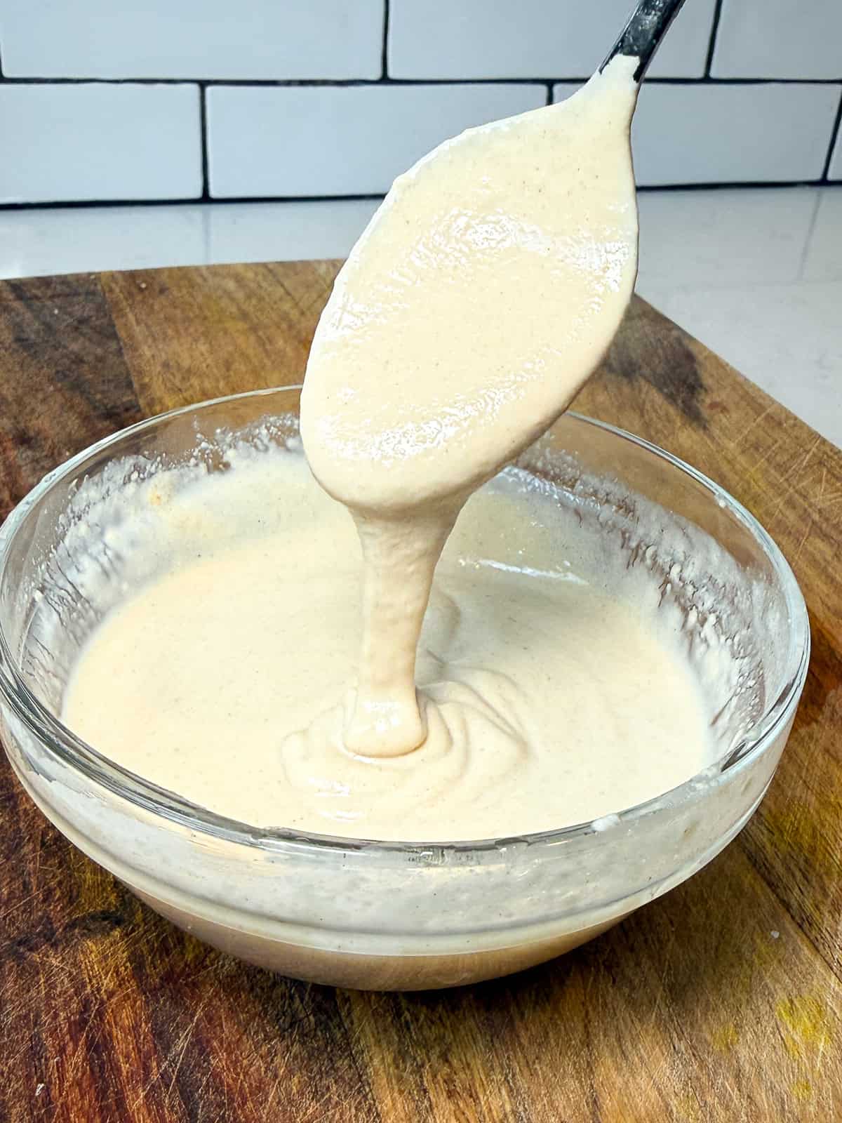 This garlic tahini sauce is perfectly savory and creamy and made easy by whisking tahini, water, garlic and lemon juice in a bowl.