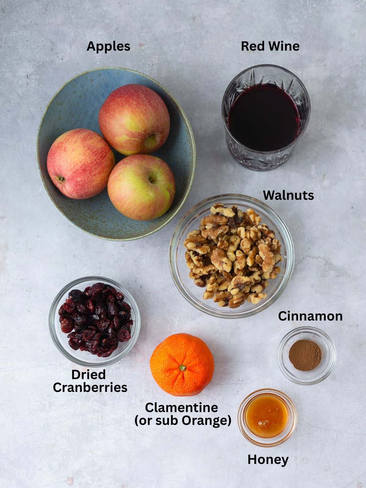 Ingredients for Passover charoset including apples, walnuts, red wine, honey and dried cranberries.