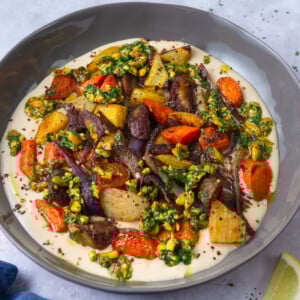 Roasted carrots with creamy tahini sauce and topped with lemony pistachios.