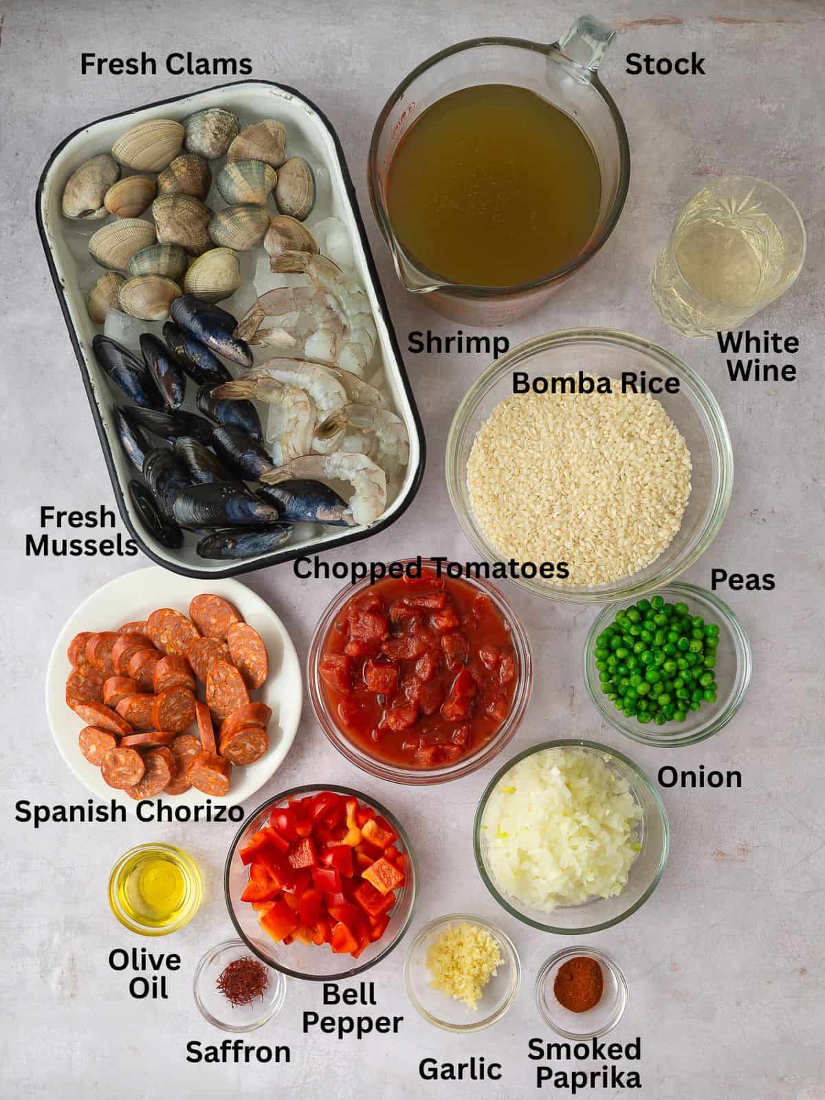 Ingredients for chorizo and seafood paella with clams, mussels, shrimp, paprika, saffron and aromatics.