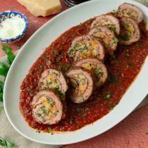 This Italian beef braciole is rolled with prosciutto and parmesan and simmered in a rich tomato sauce until perfectly tender.