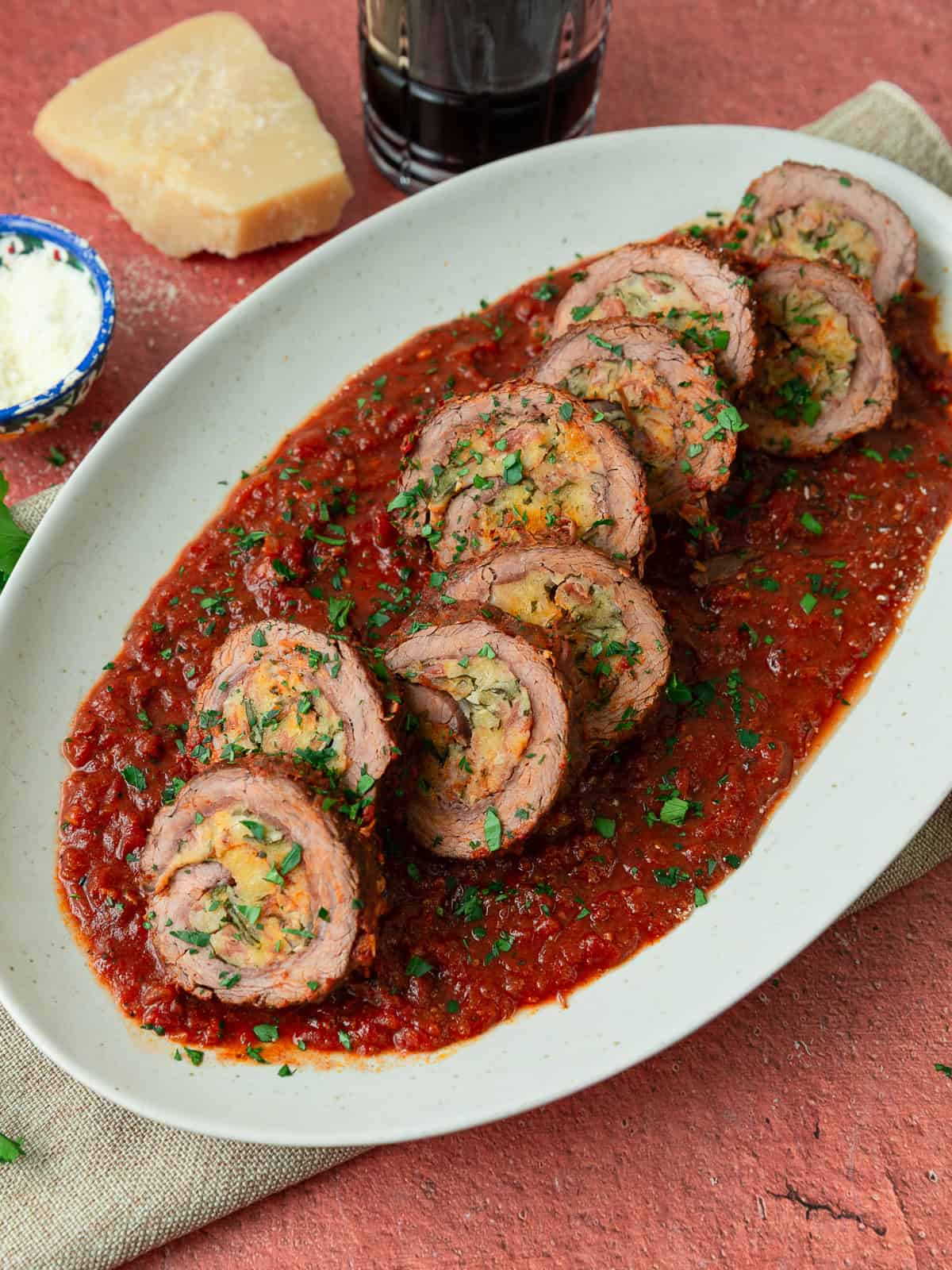 This beef braciole is stuffed with a savory prosciutto and parmesan mixture and simmered in a rich tomato sauce until perfectly tender.