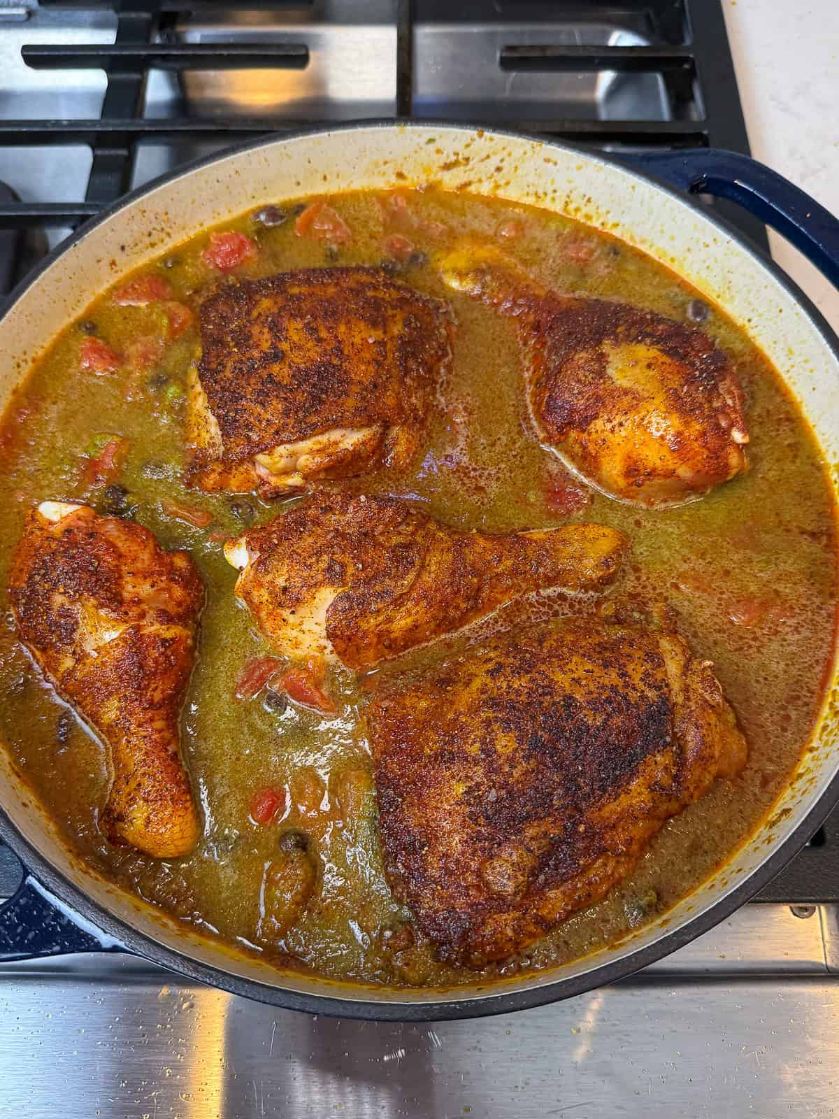 Braise the sazon chicken with the tomatoes, beans and sofrito.
