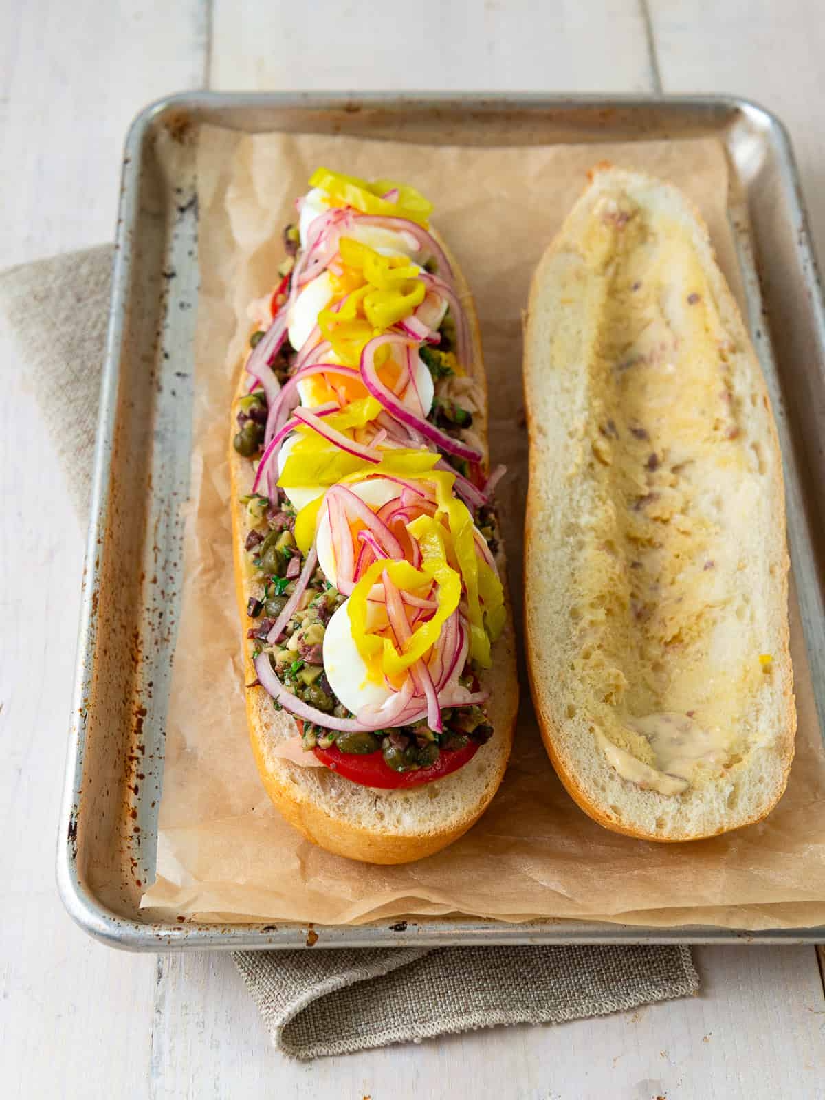 Open faced nicoise sandwich with olives, tuna, pickled onions and a perfectly medium boiled egg.