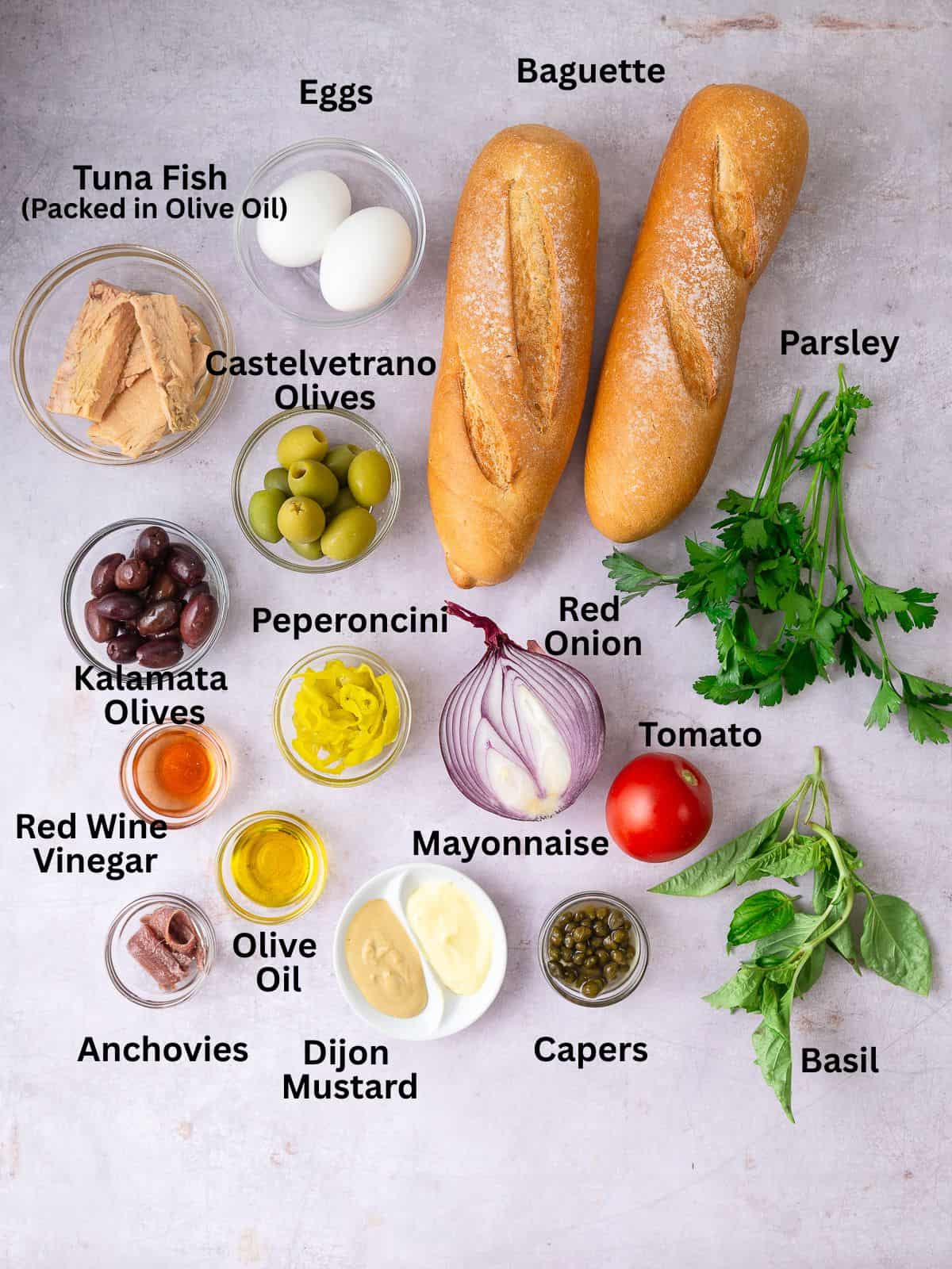 Ingredients for Nicoise sandwich, including olives, capers, tuna and anchovies.