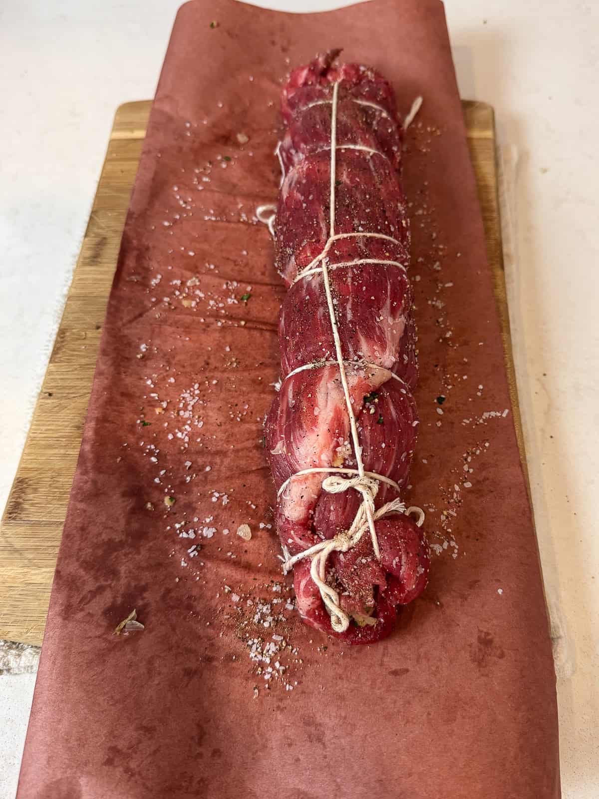 Use butcher twine to tie around the rolled braciole.