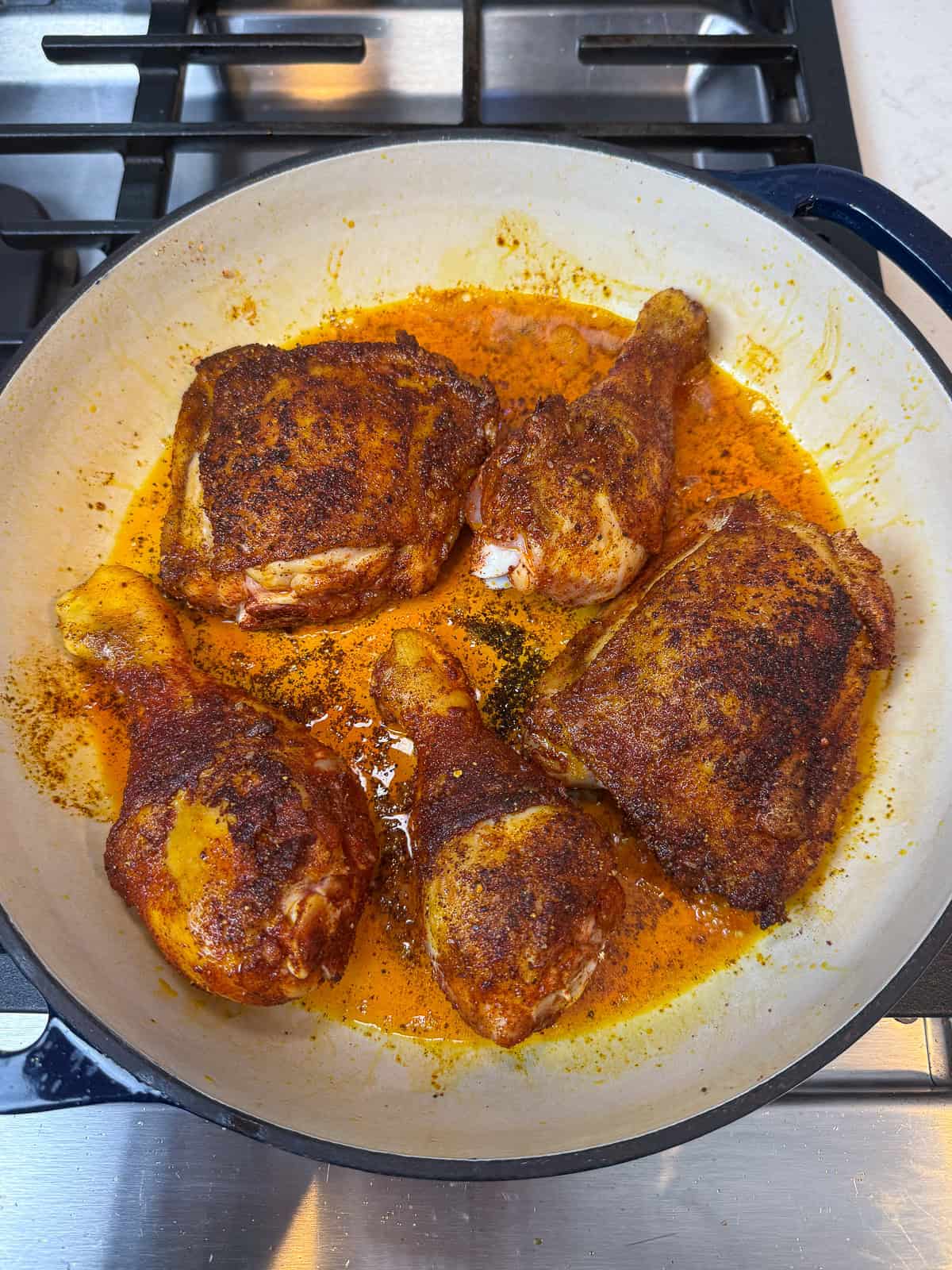 Sear the seasoned sazon chicken until the skin is deeply golden and fat has rendered, then remove and set aside.