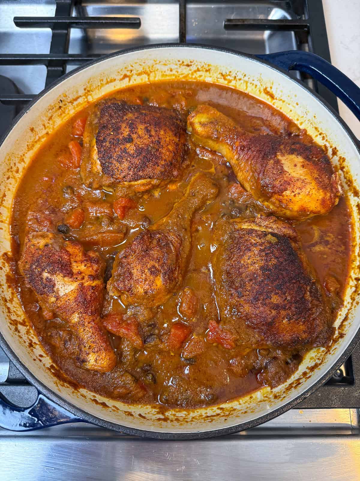 Simmer the one pot sazon chicken until the liquid has reduced and the chicken is cooked all the way through.