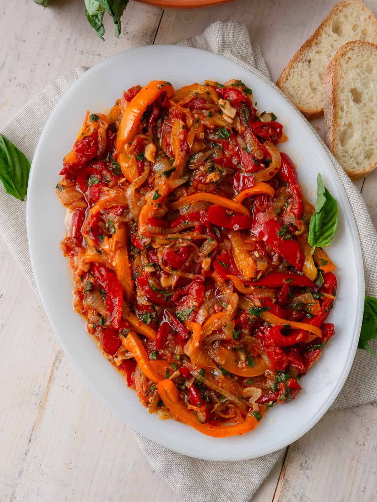 This Italian peperonata is layered with sautéed peppers, onions and tomatoes and finished with a bright pop of vinegar and fresh basil. It makes a delicious appetizer.