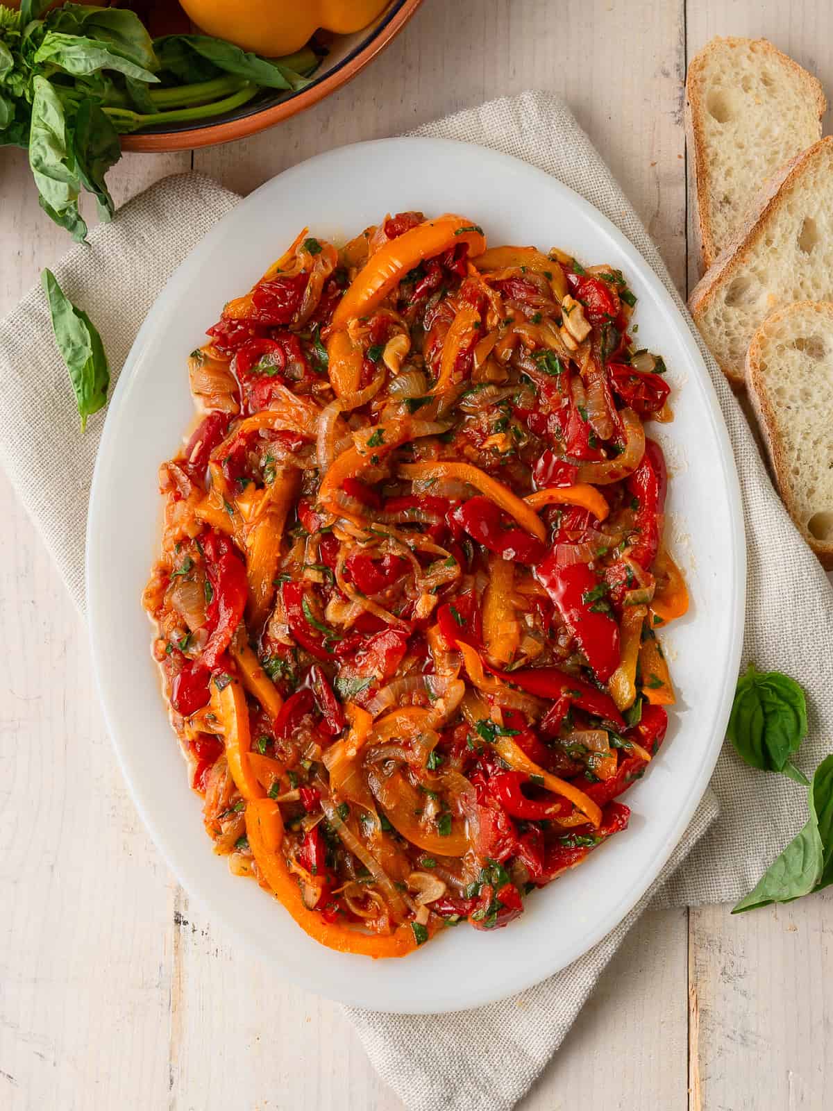 This easy peperonata is an Italian antipasti with sautéed onions, peppers and tomatoes and finished with vinegar and basil for a pop of brightness.