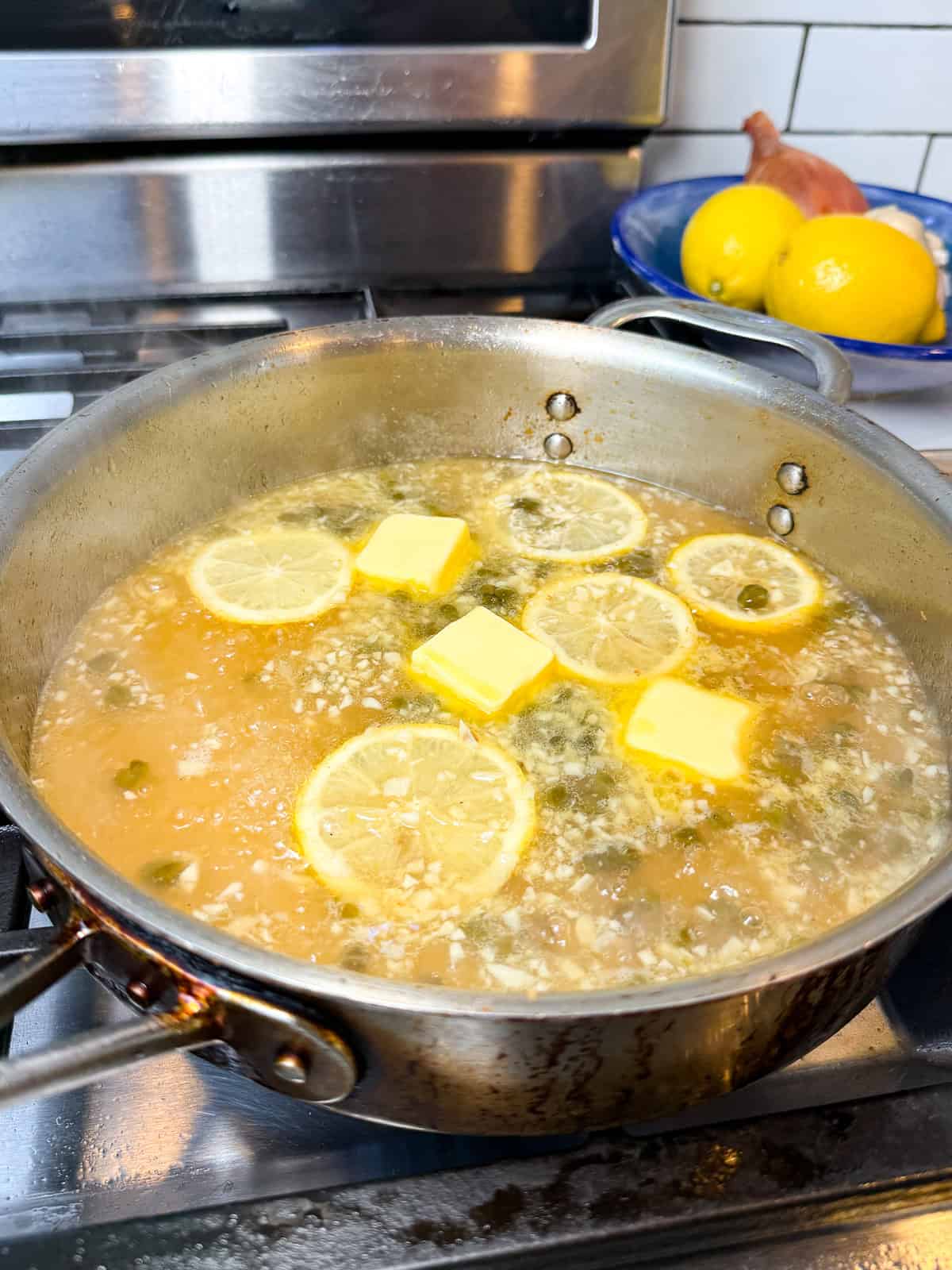 Add butter and lemon to the piccata sauce.
