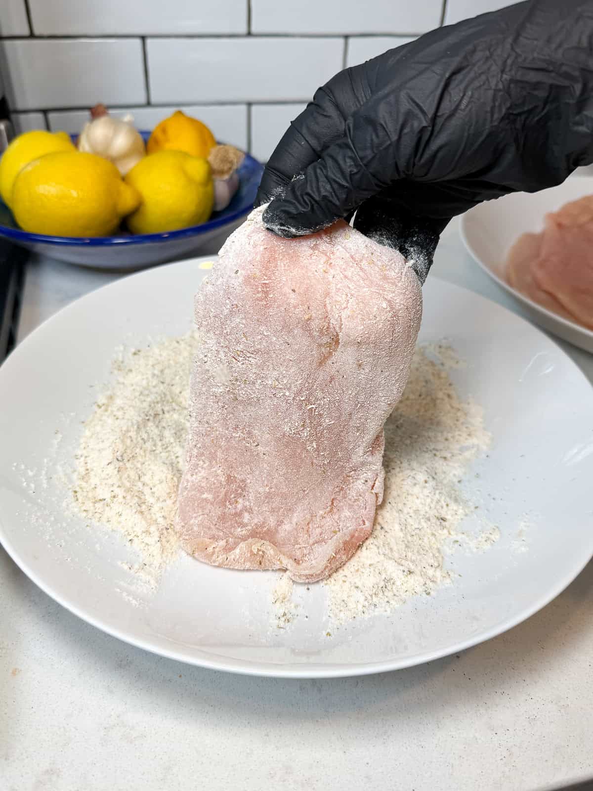 Dredge the chicken cutlets in the seasoned flour.