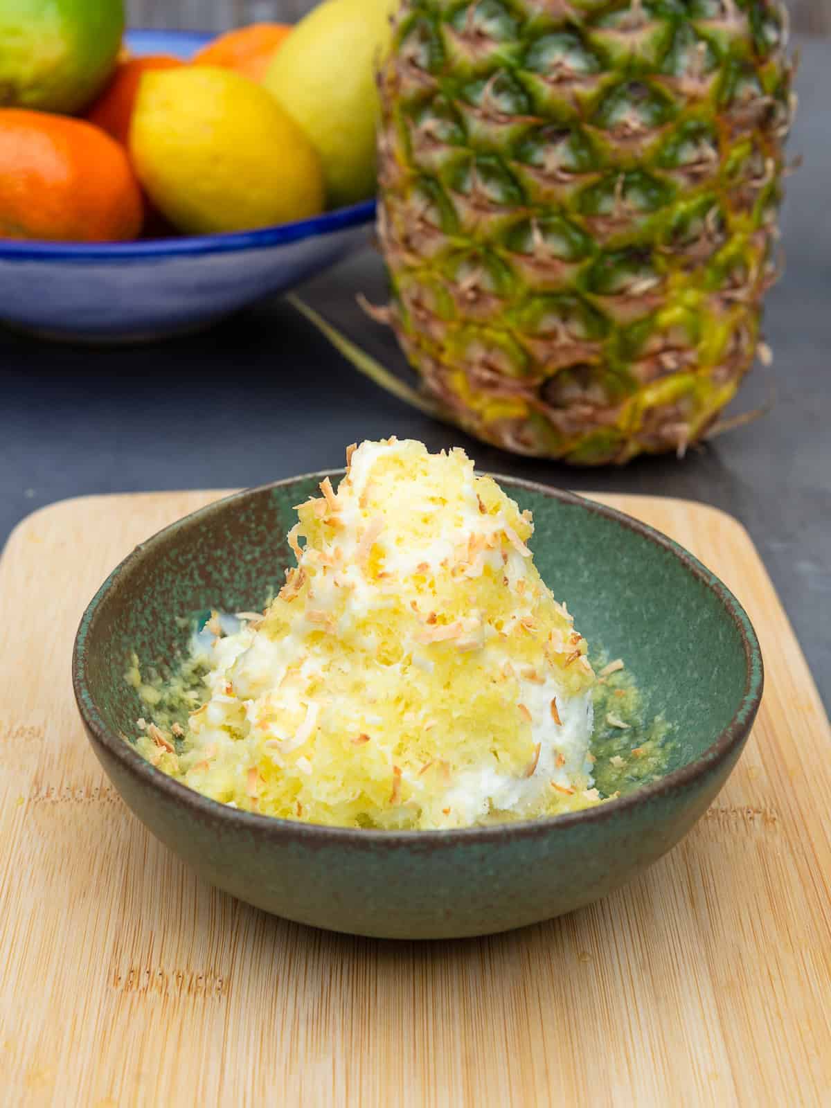 This frozen shaved pineapple is the easiest dessert! Serve on top of ice cream and finish with a drizzle of condensed milk and toasted coconut.