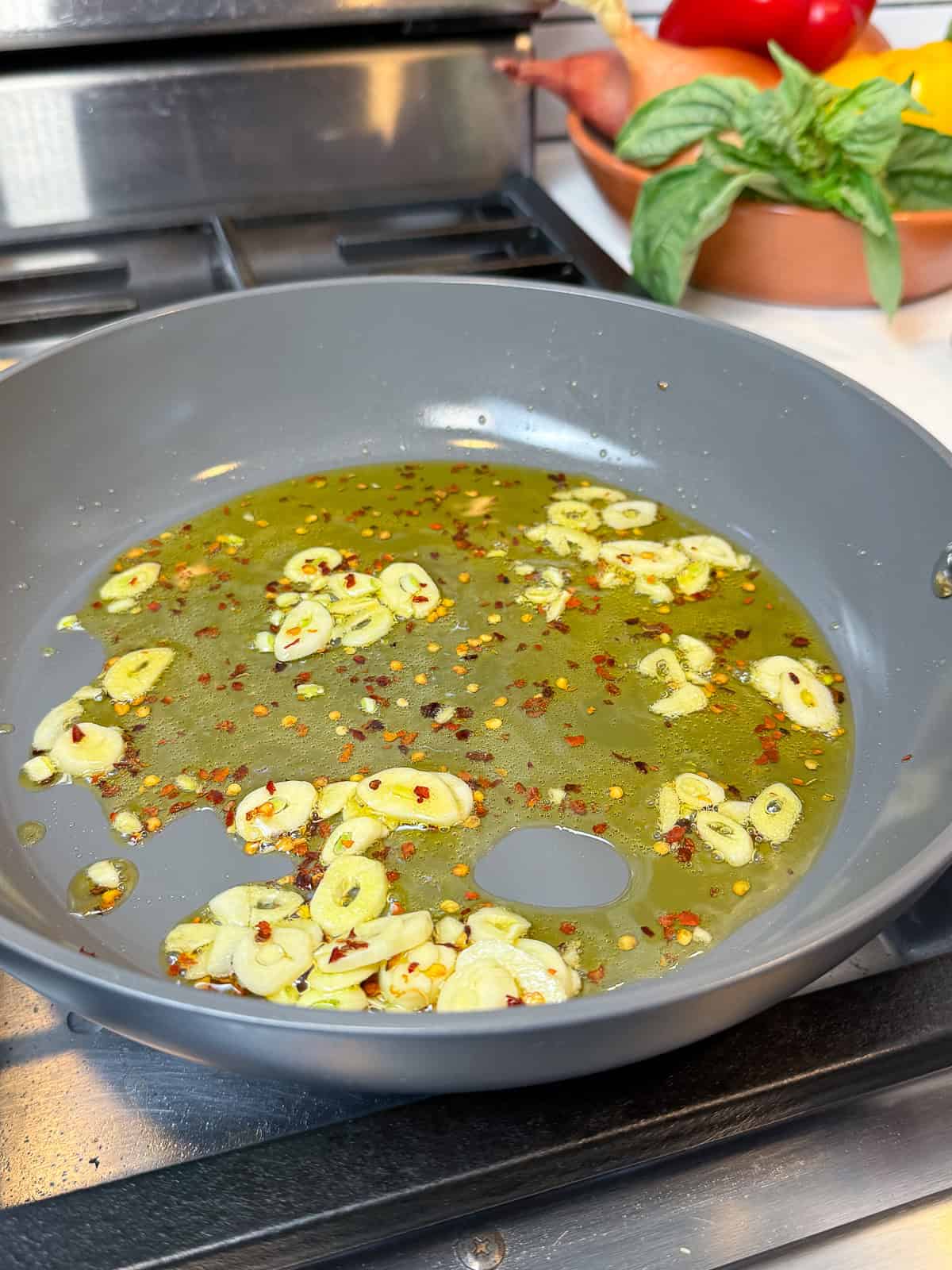 Saute sliced garlic and red pepper flakes in olive oil until lightly golden.