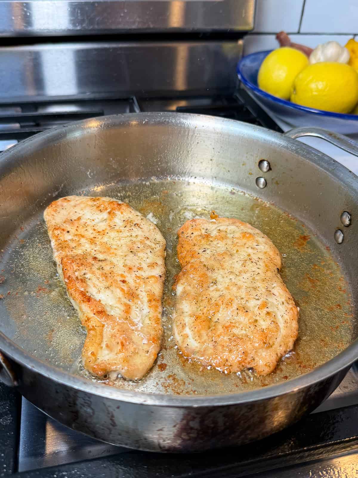 Sear the dredged chicken cutlets in olive oil until cooked through and golden on both sides.