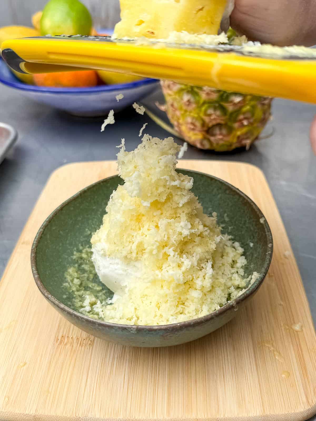 Use a microplane or grater to shave the frozen pineapple over the ice cream.