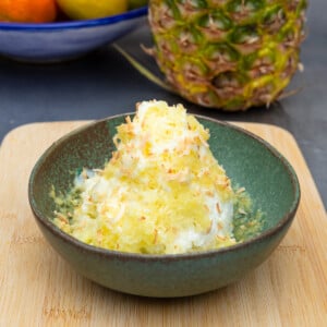 Frozen shaved pineapple is dusted over vanilla ice cream and finished with condensed milk and toasted coconut.