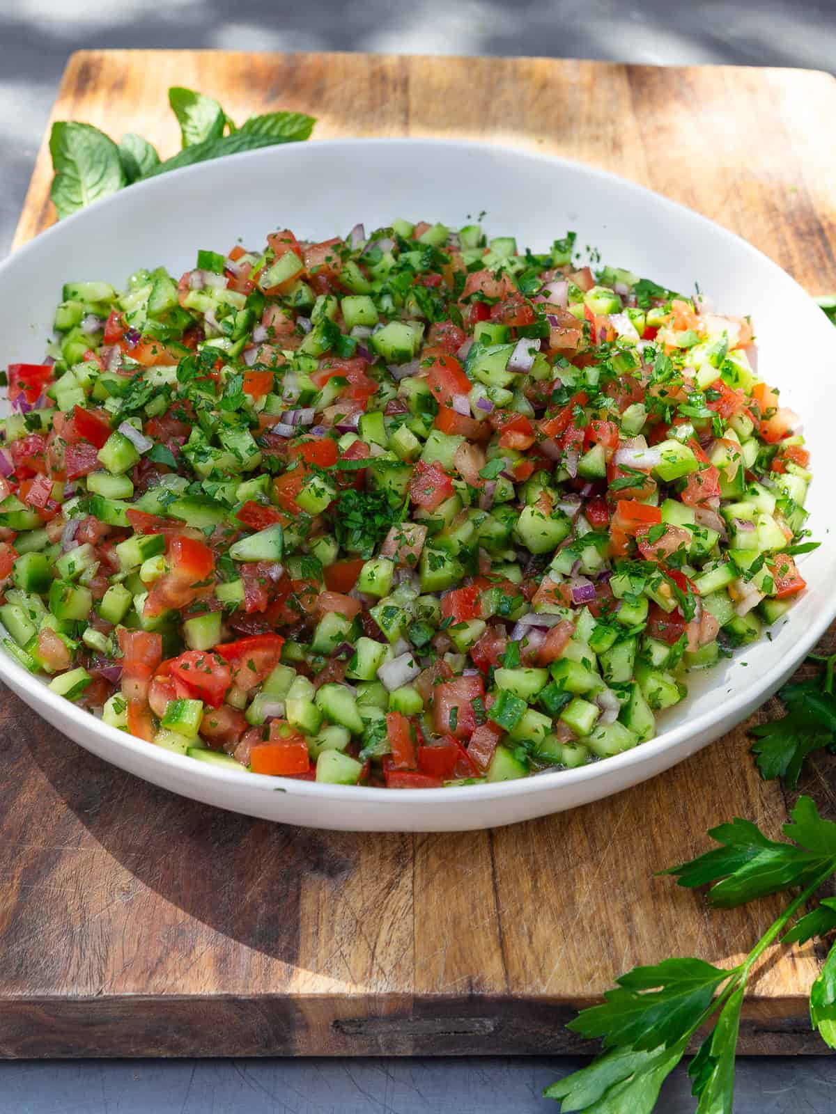 This shirazi salad is a Persian salad made with diced tomato, cucumber, red onion and dressed with fresh herbs, lemon juice and olive oil.