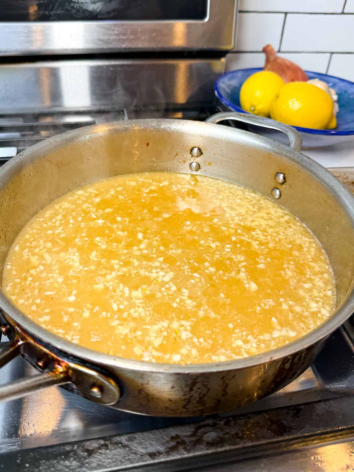 Simmer the lemon piccata sauce until slightly thickened.