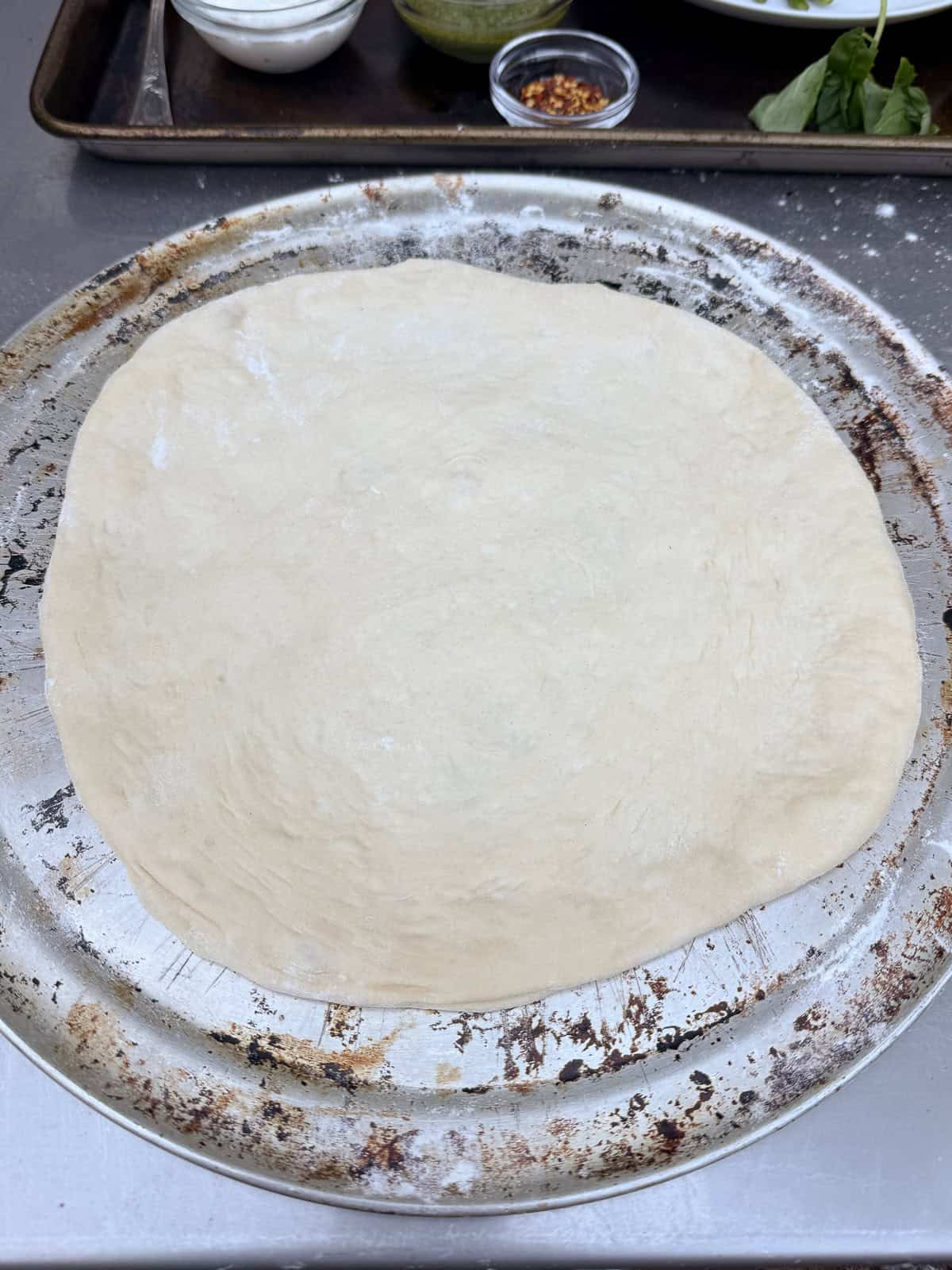 Stretch the pizza dough into a round 10 inch circle.