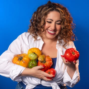 Samantha Ferraro holding a handful of colorful heirloom tomatoes