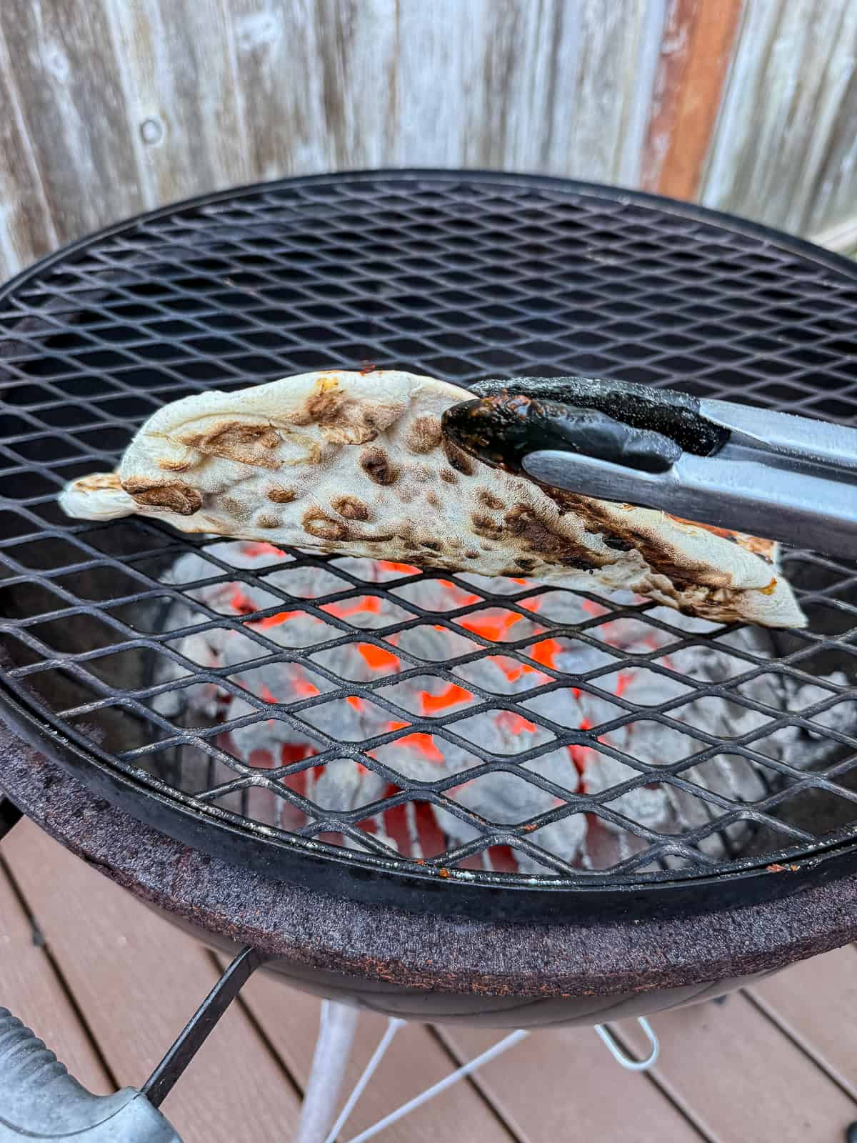Grill the first side of the pizza dough until lightly charred.