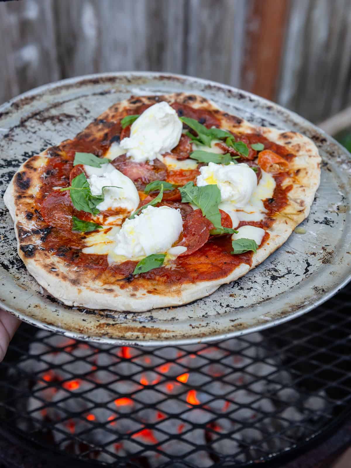 Learn to grill pizza right on a hot grill without a pizza stone.