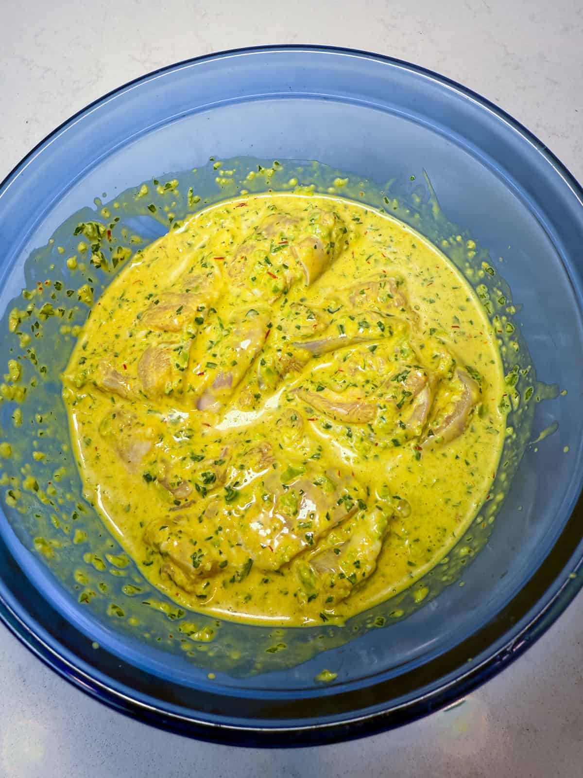 Marinade the chicken in the yogurt saffron mixture.