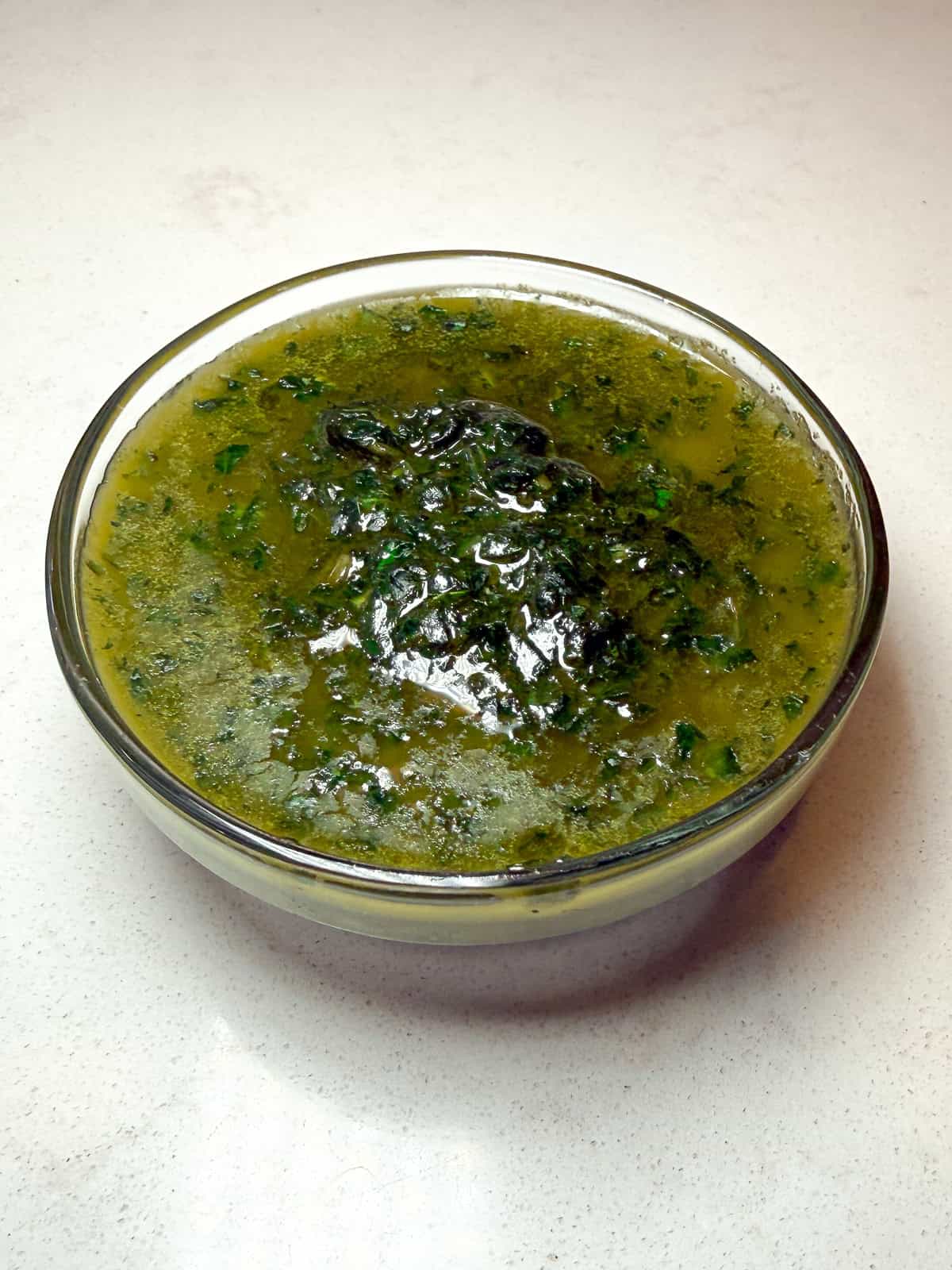 Simple basil oil made with olive oil and fresh basil blended together.