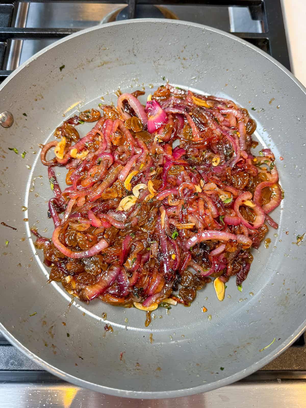 Cook the sweet onion agrodolce until everything is slightly thickened and caramelized.
