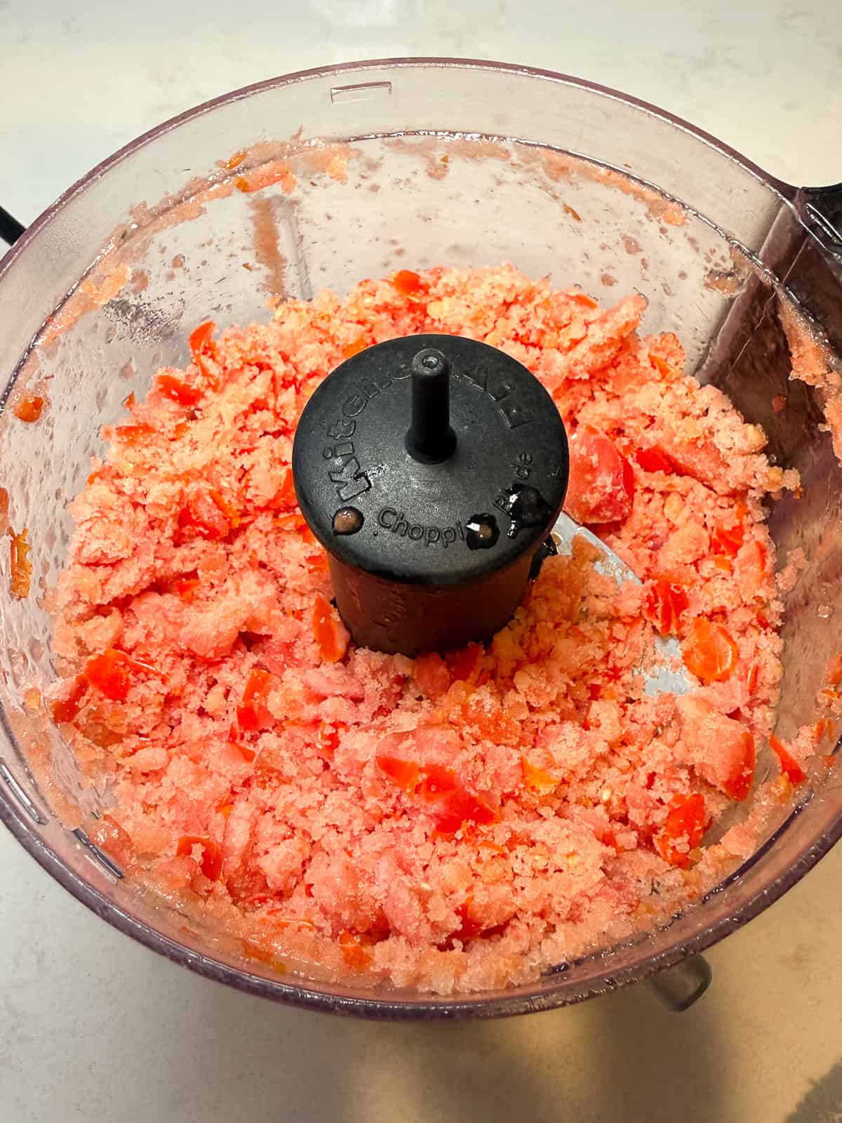 Add the frozen cherry tomatoes to a food processor and pulse a few times until you get a granita texture.