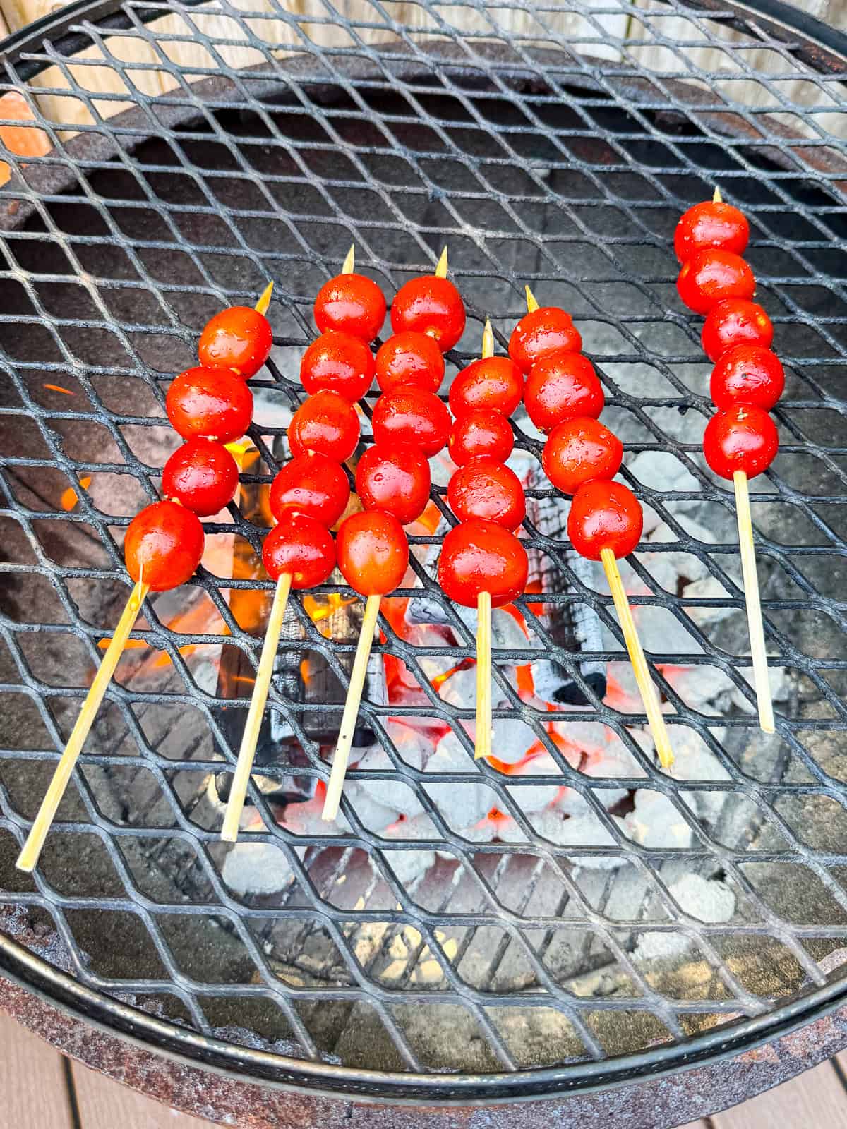 Grill the cherry tomato skewers until lightly charred on all sides.