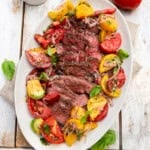 Grilled ribeye steak with a colorful heirloom tomato salad.