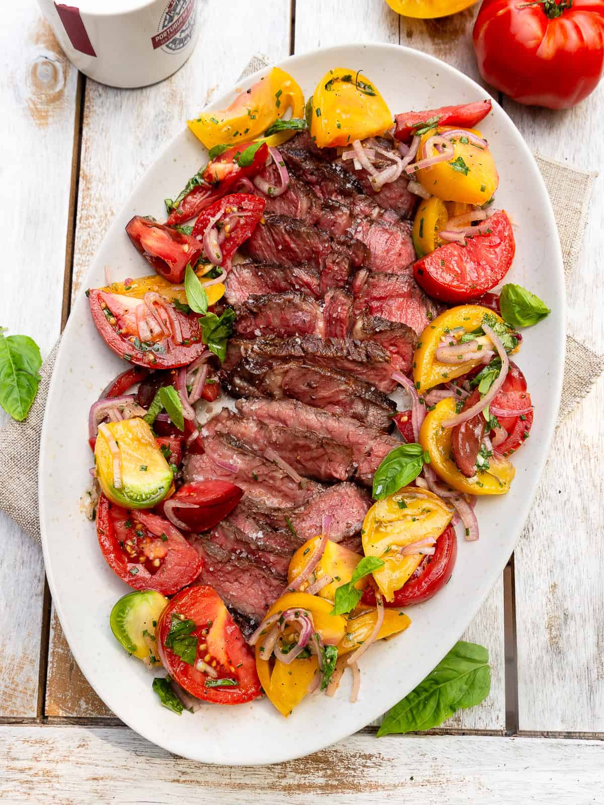 Grilled ribeye with a colorful heirloom tomato salad with shallots and fresh herbs.