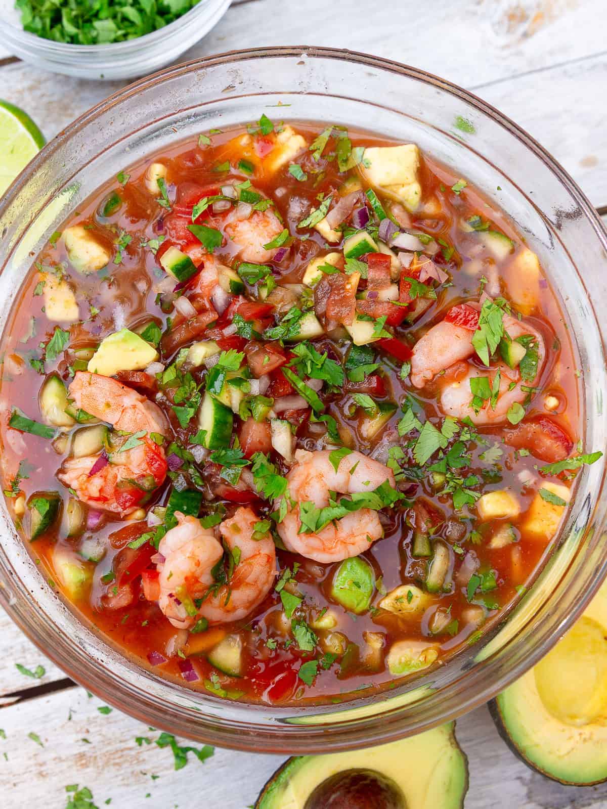 To a large bowl, mix the Mexican shrimp cocktail together and combine the shrimp, vegetables, herbs and cocktail sauce.