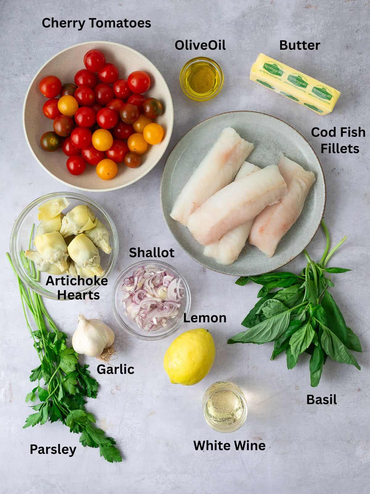 Ingredients for one pan cod with cherry tomatoes, including artichoke hearts, white wine and fresh herbs.