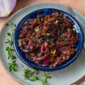 This easy onion agrodolce is flavored with garlic, sweet golden raisins and tangy vinegar.