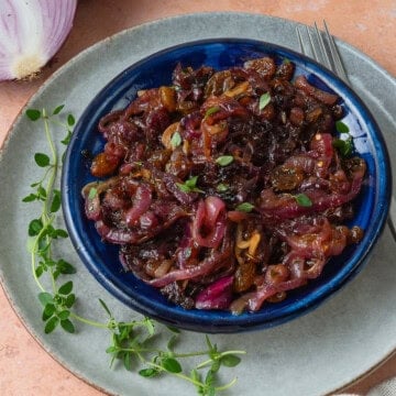 This easy onion agrodolce is flavored with garlic, sweet golden raisins and tangy vinegar.