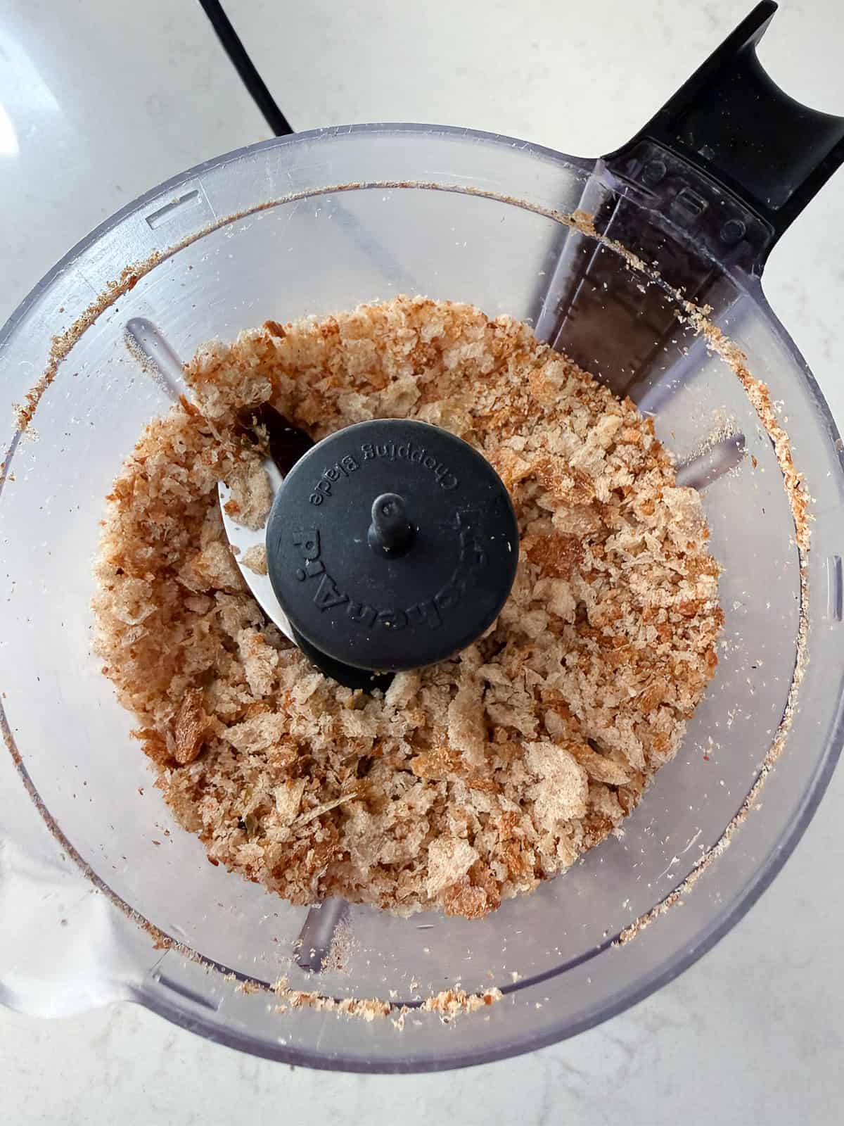 Add day old bread cubes to a food processor and pulse a few times until you get breadcrumbs.