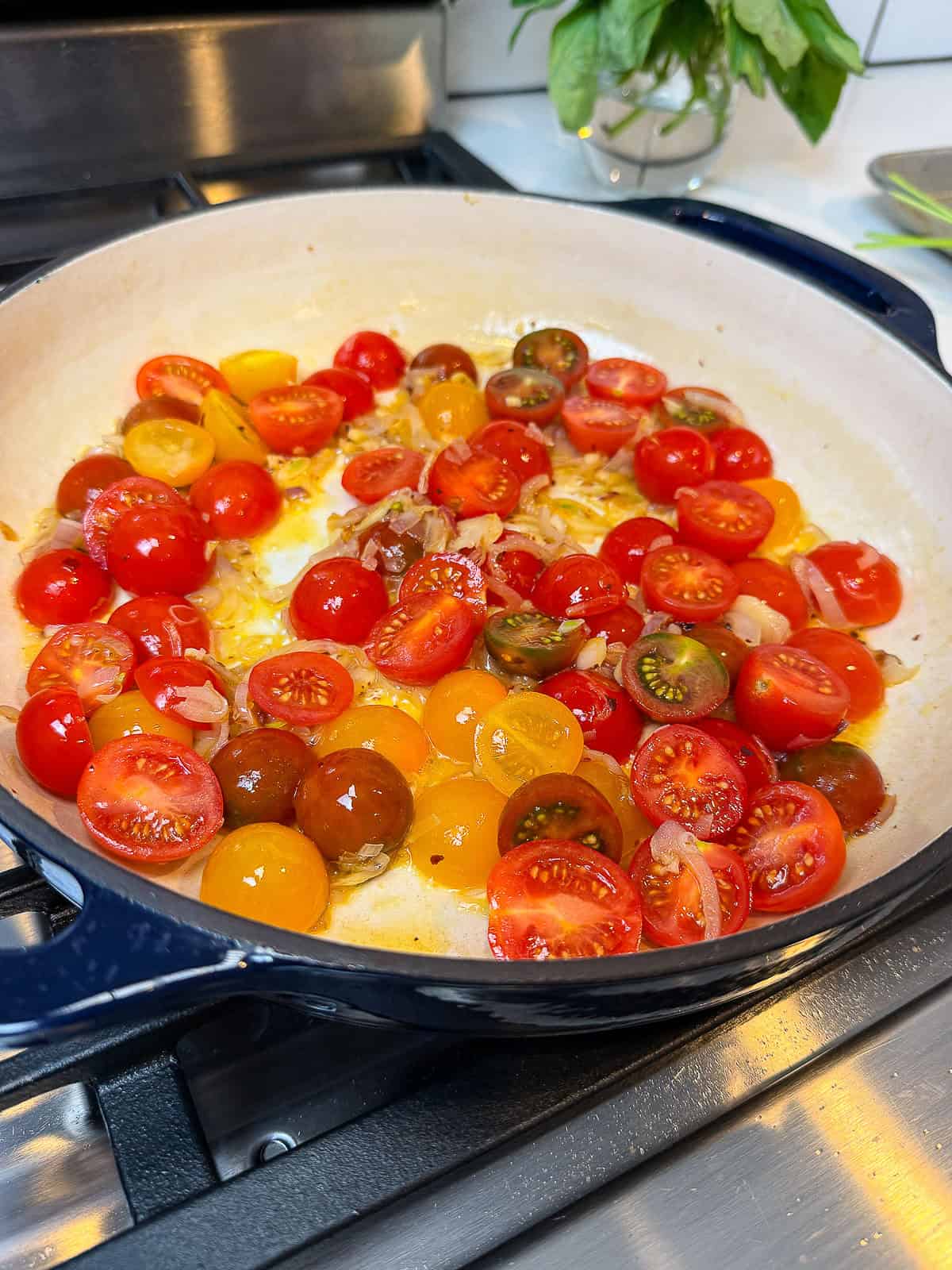 Add cherry tomatoes to the shallots and garlic and saute to soften.
