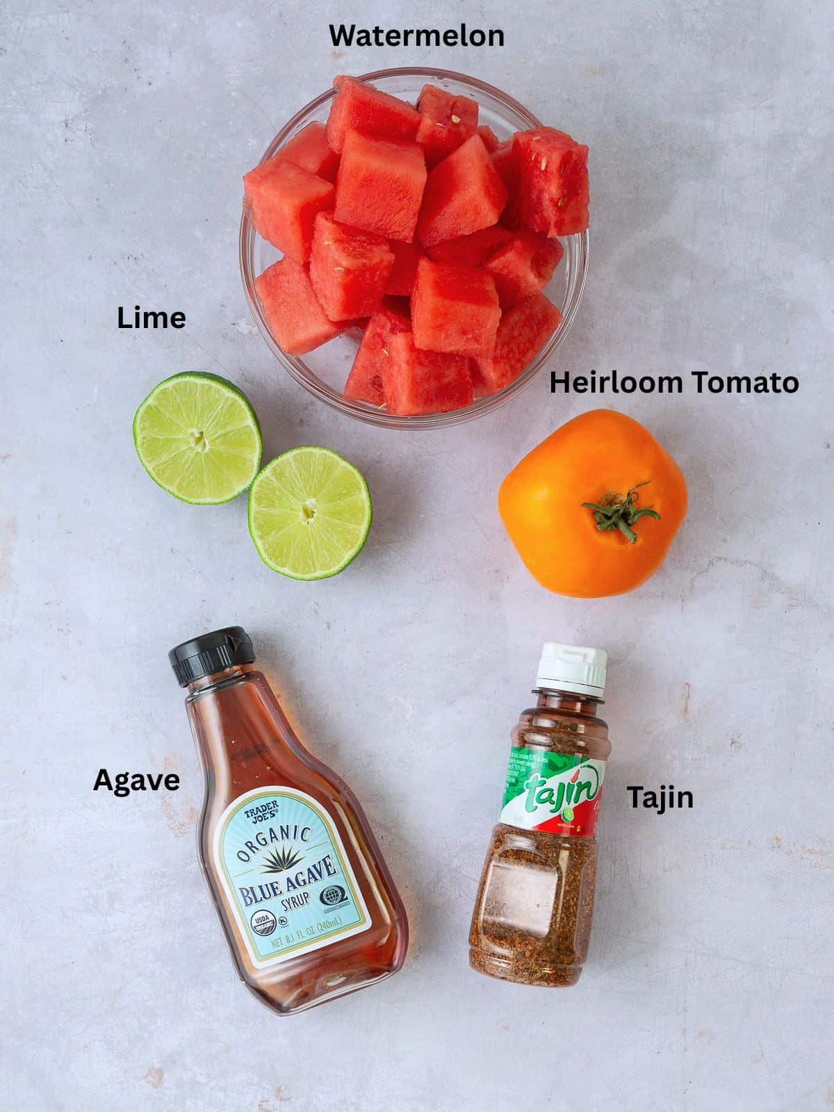 Ingredients for watermelon and tomato agua fresca with fresh lime juice, agave and tajin.