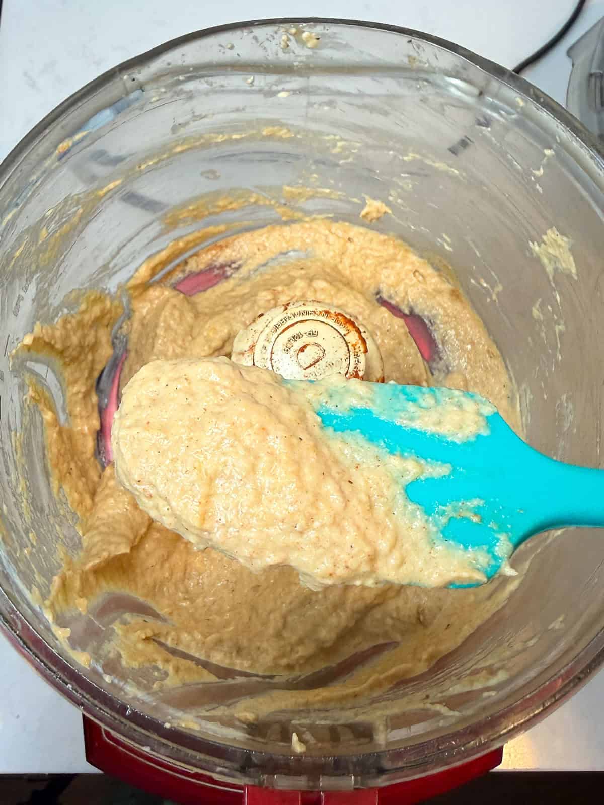 To a food processor, add the roasted zucchini flesh, tahini, lemon zest and juice, garlic and spices and pulse a few times until just blended.