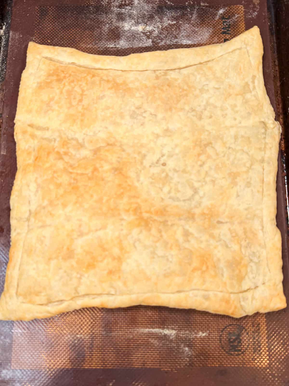 Par bake the puff pastry until lightly golden brown.