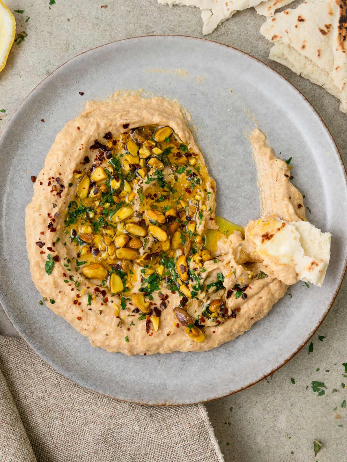 Smoky zucchini baba ghanoush made with roasted zucchini, tahini, lemon, fresh mint, and toasted pistachios.